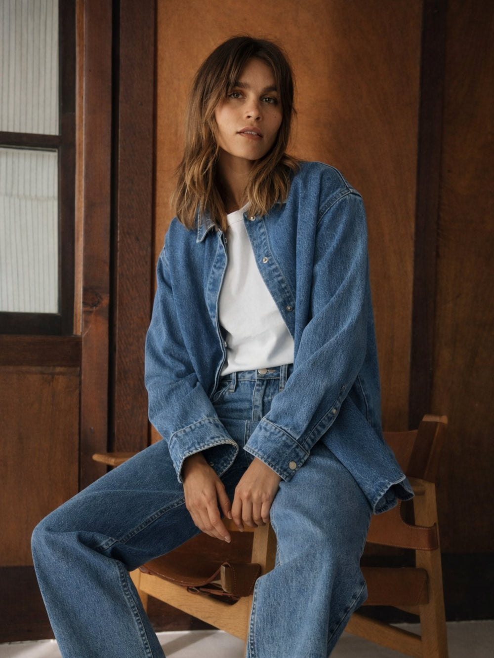 Side angle of blue oversized denim shirt