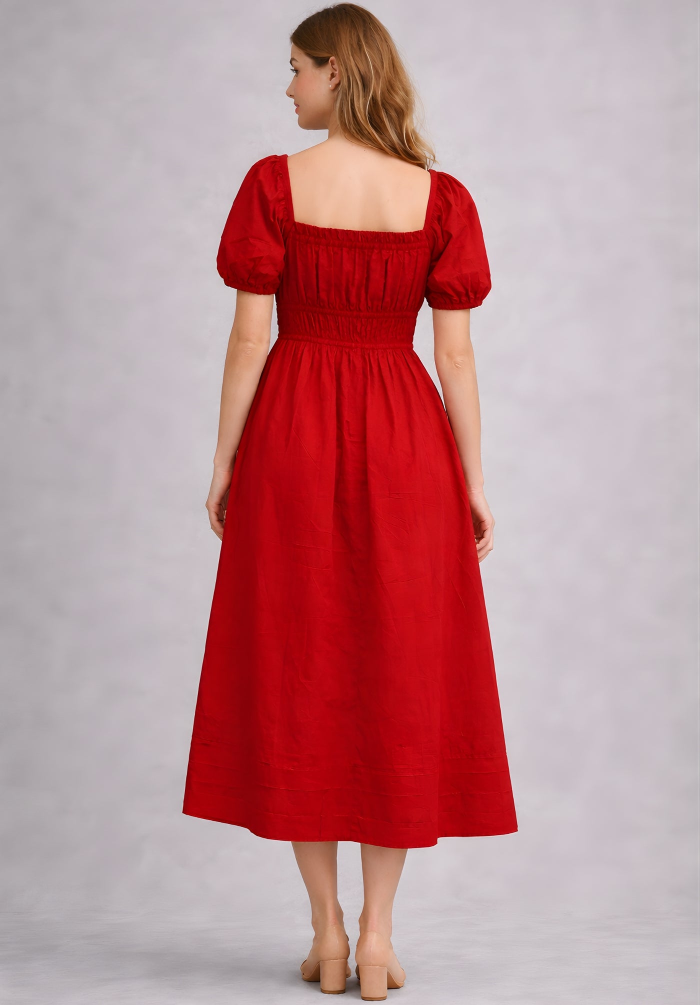 Back view of red cotton A-line dress with flared midi hemline