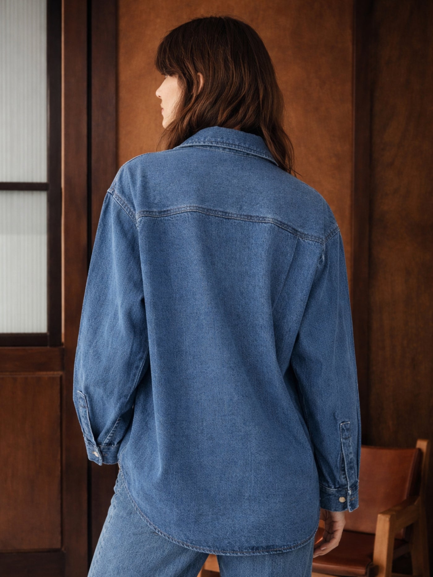 Detail of buttoned cuff on blue denim shirt