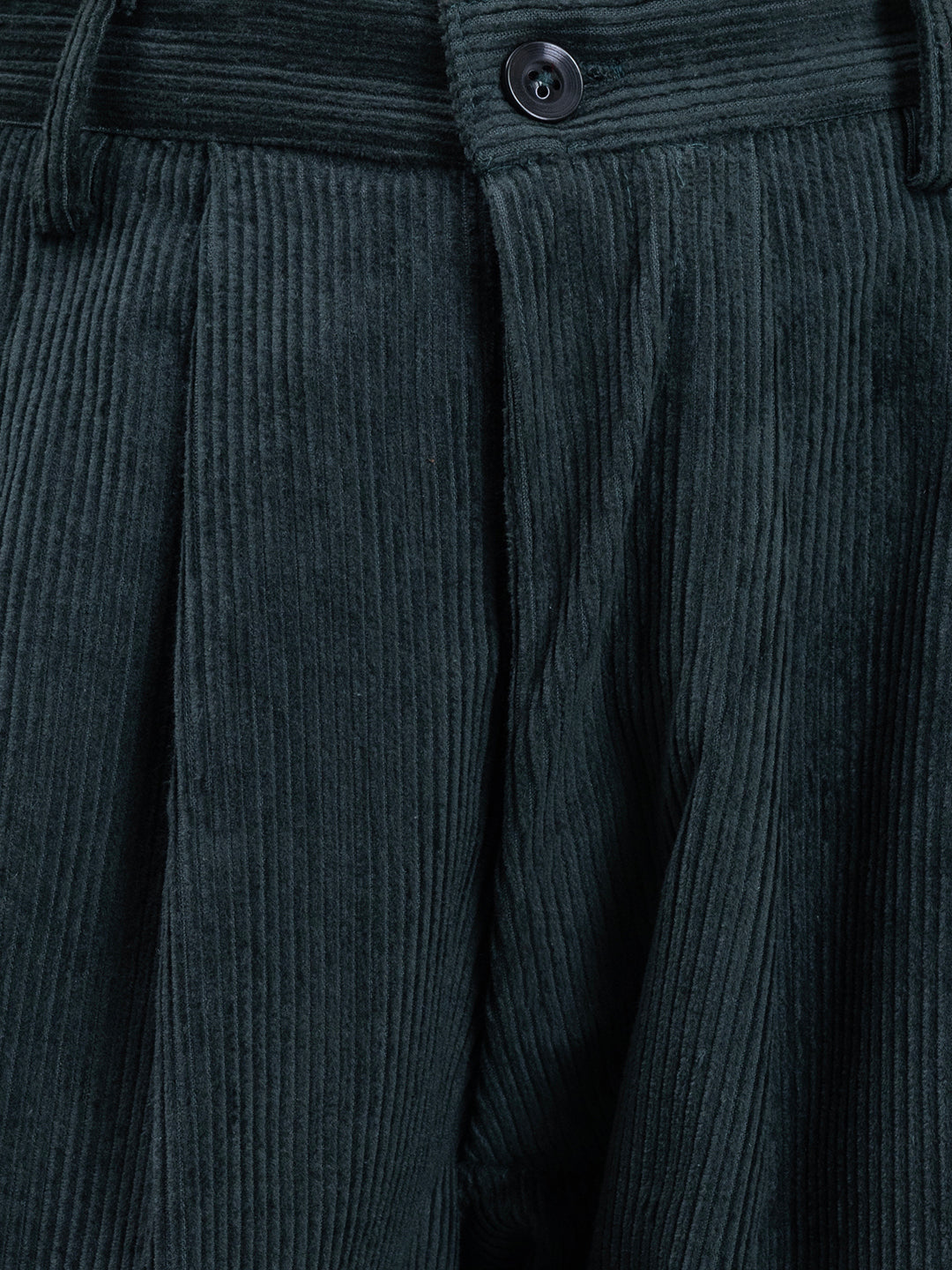 Detail of drawstring waistband on green corduroy trousers