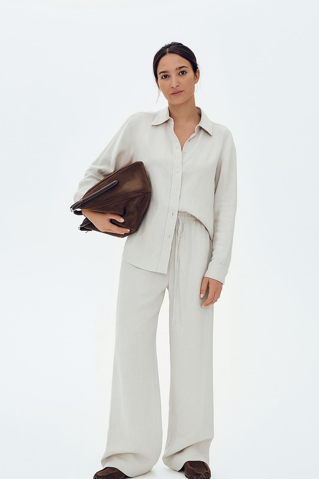 Lifestyle shot of off-white baggy trousers with relaxed straight legs