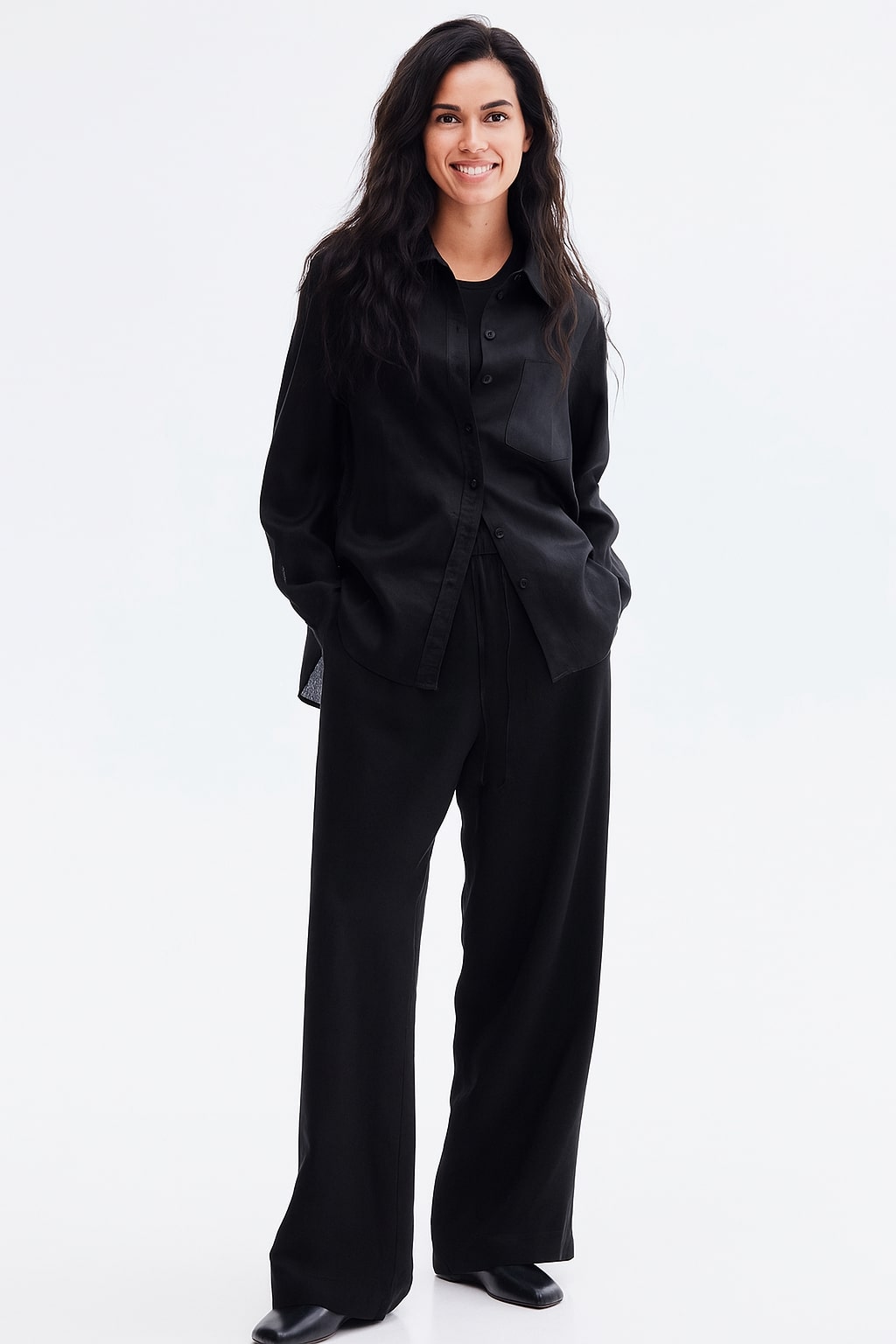 Lifestyle shot of black baggy trousers with relaxed straight legs