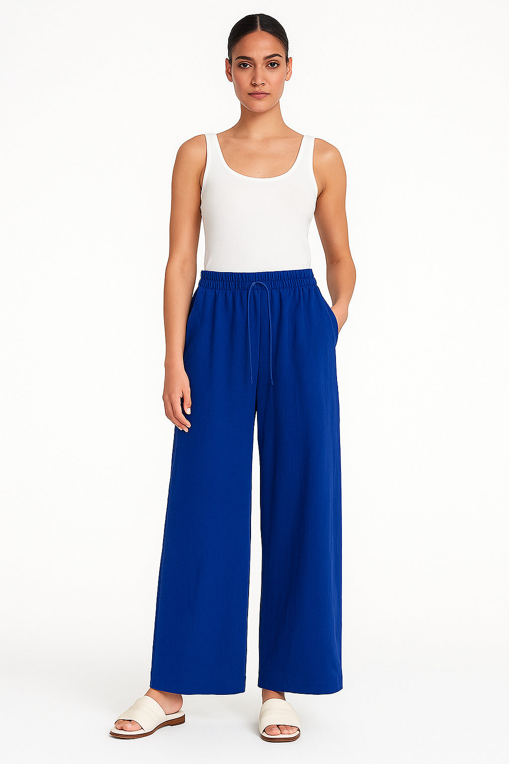 Lifestyle shot of blue linen blend baggy trousers styled with top