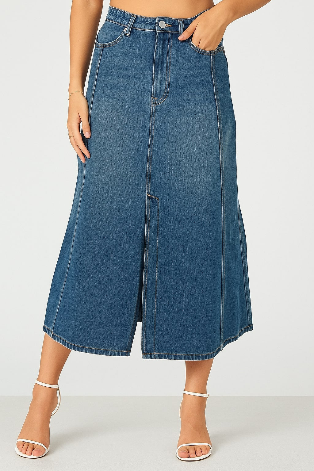Lifestyle shot of blue denim skirt styled with a tucked tee