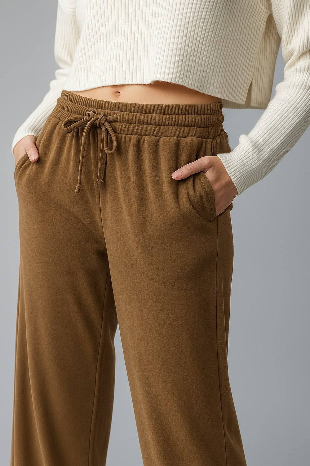 Brown velvet drawstring trousers full-length on model