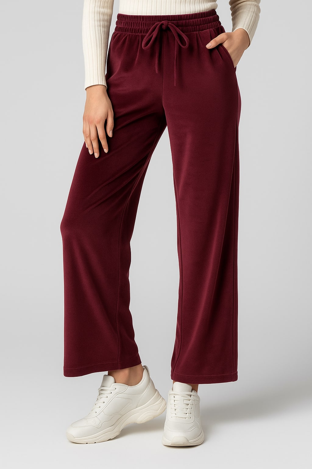 Front view of maroon velvet drawstring trousers with straight legs