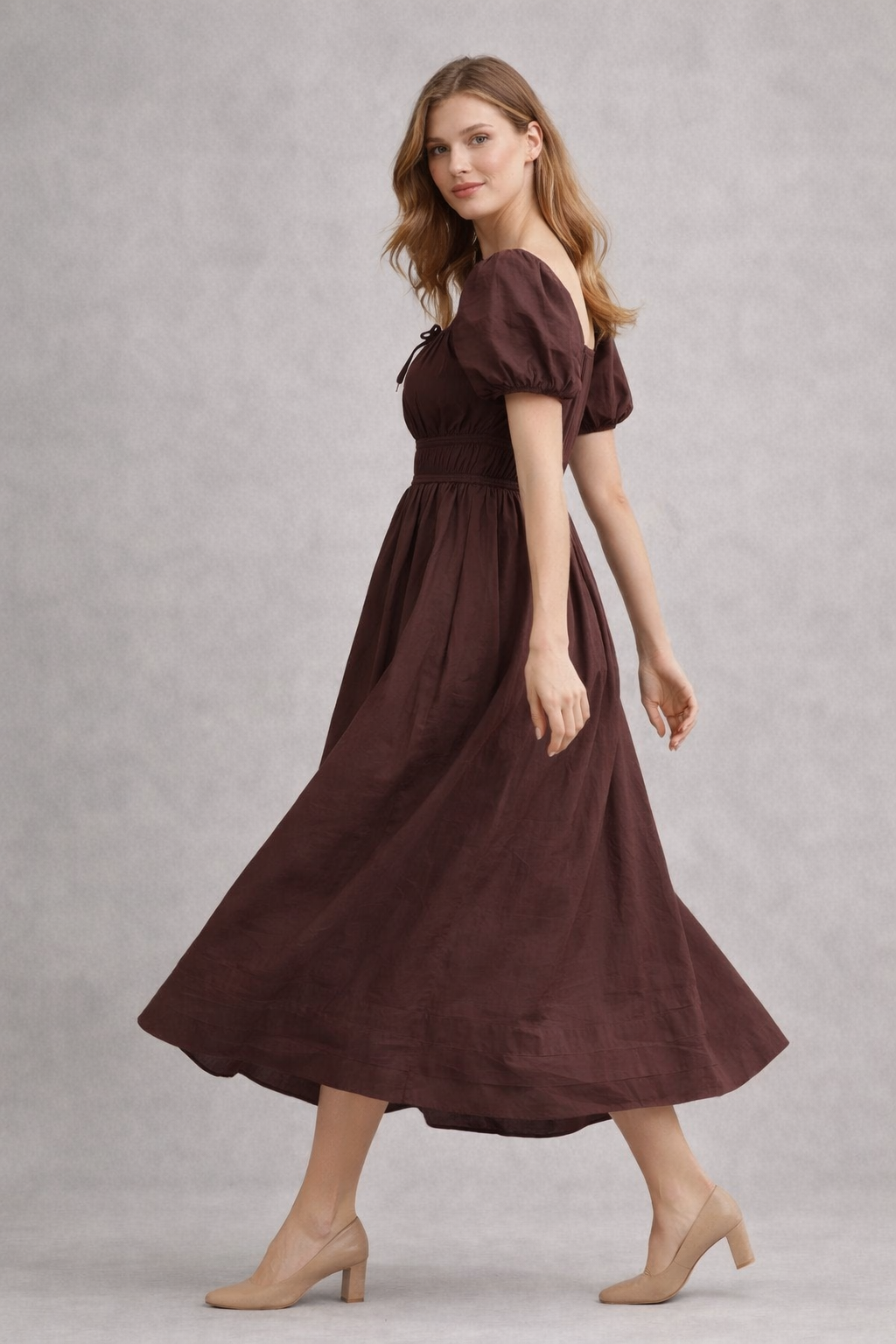 Close-up of smocked waist detail on brown dress