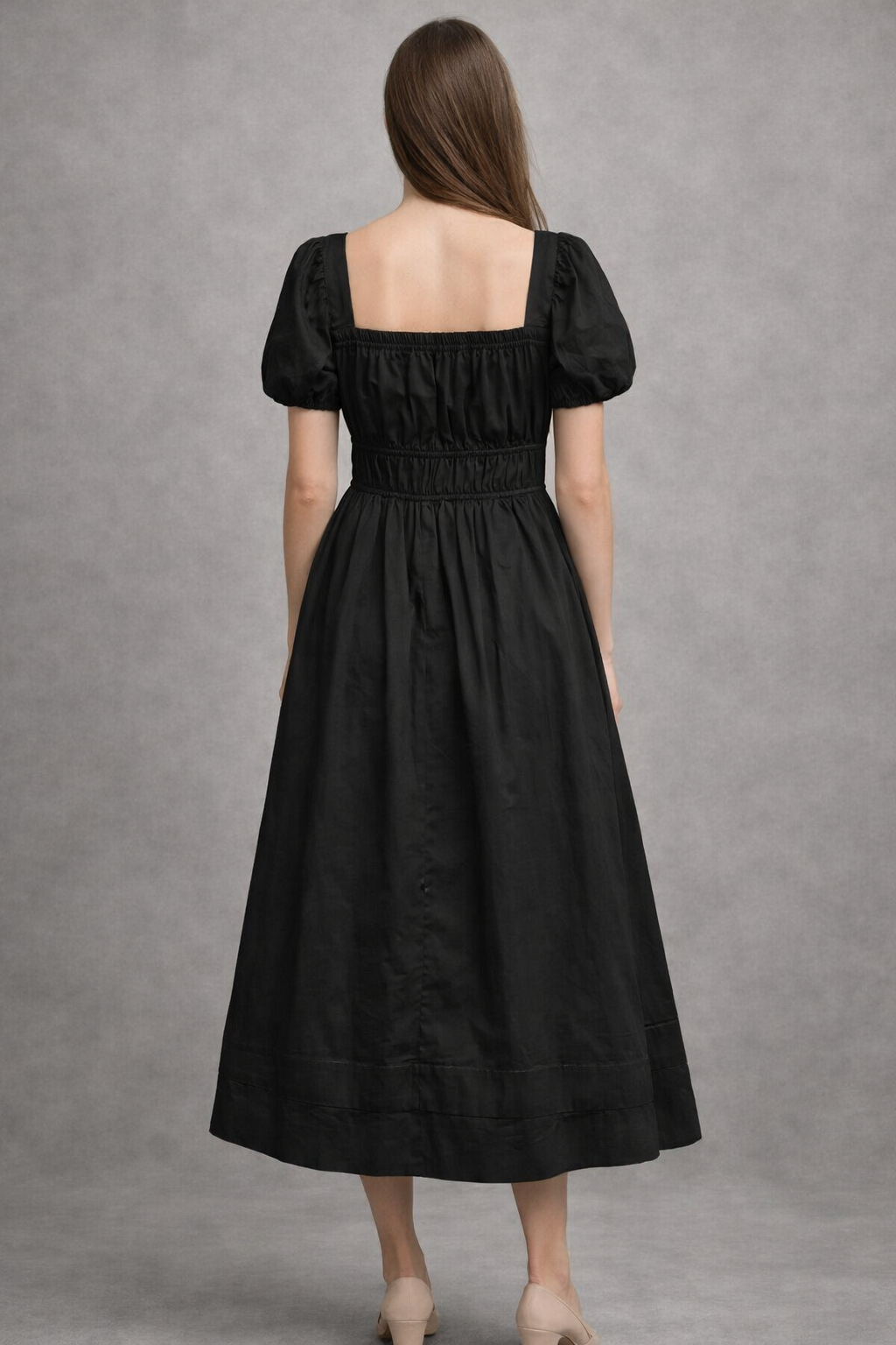 Close-up of smocked waist detail on black dress