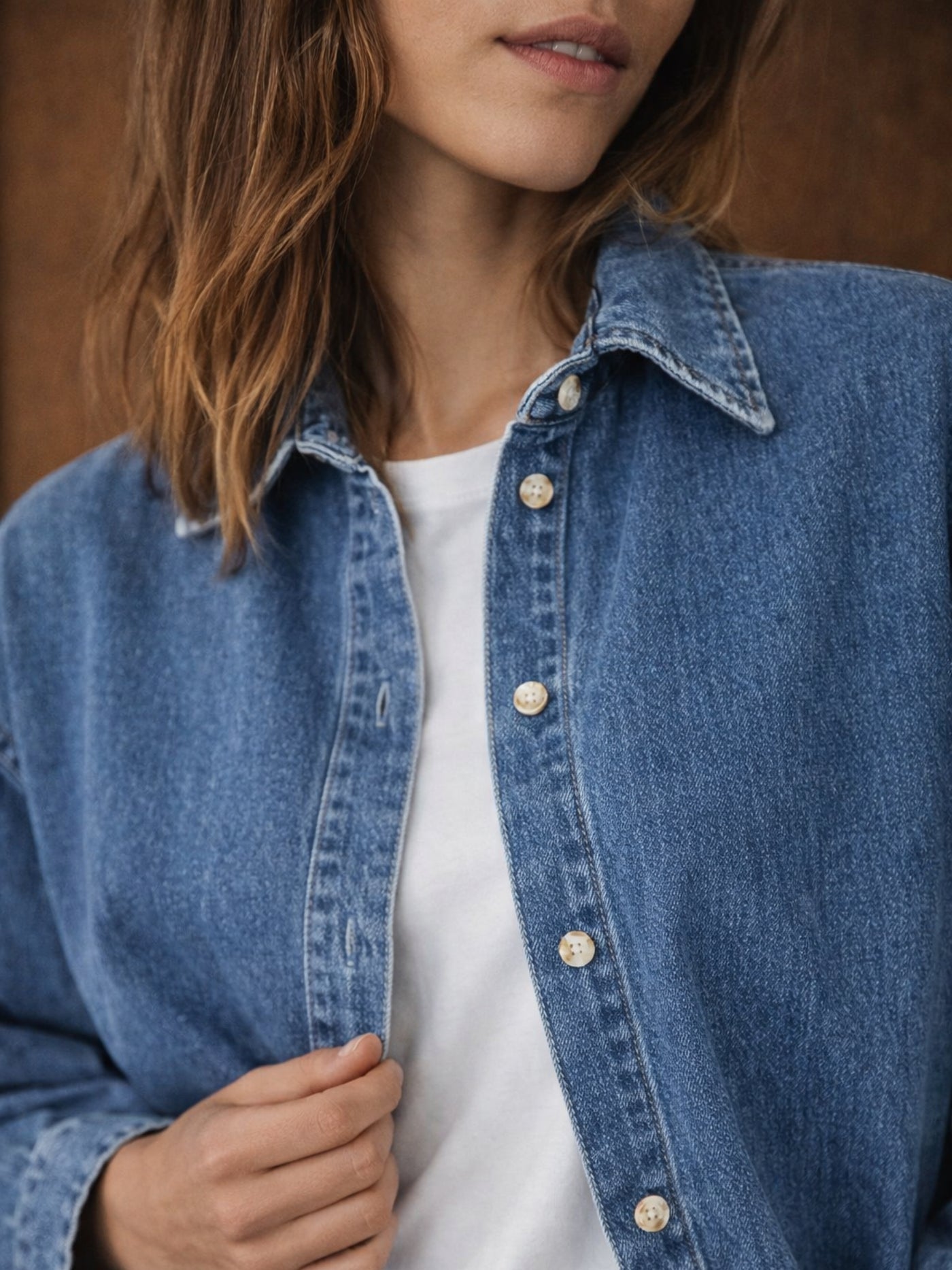 Lifestyle shot of blue oversized denim shirt styled with denim