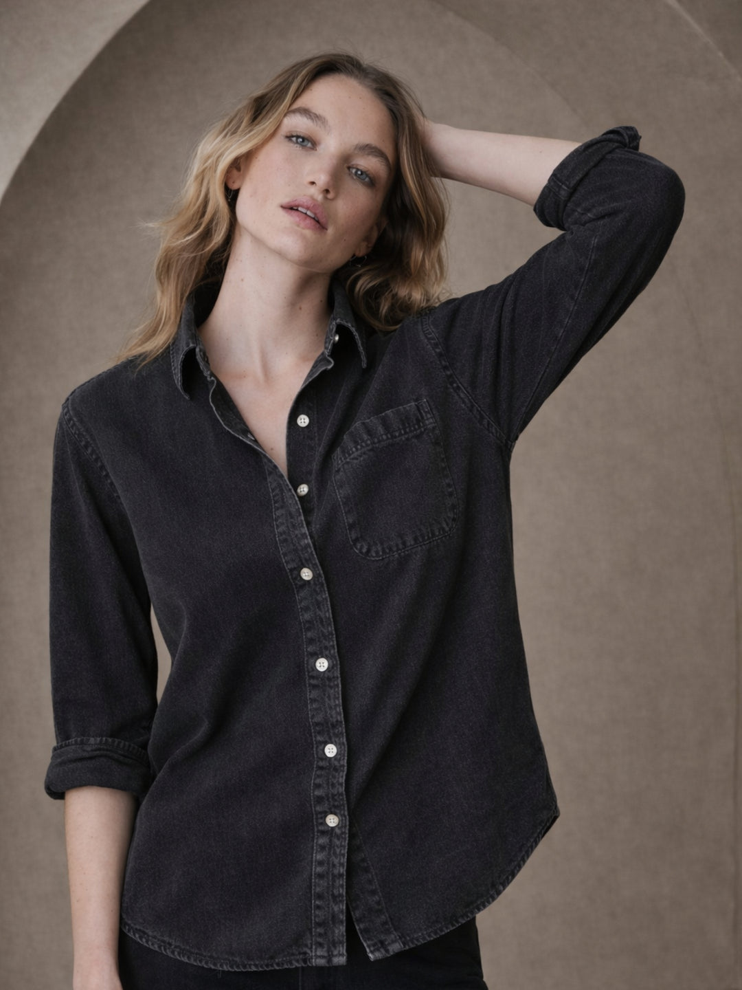 Front view of black oversized denim shirt with pockets for women