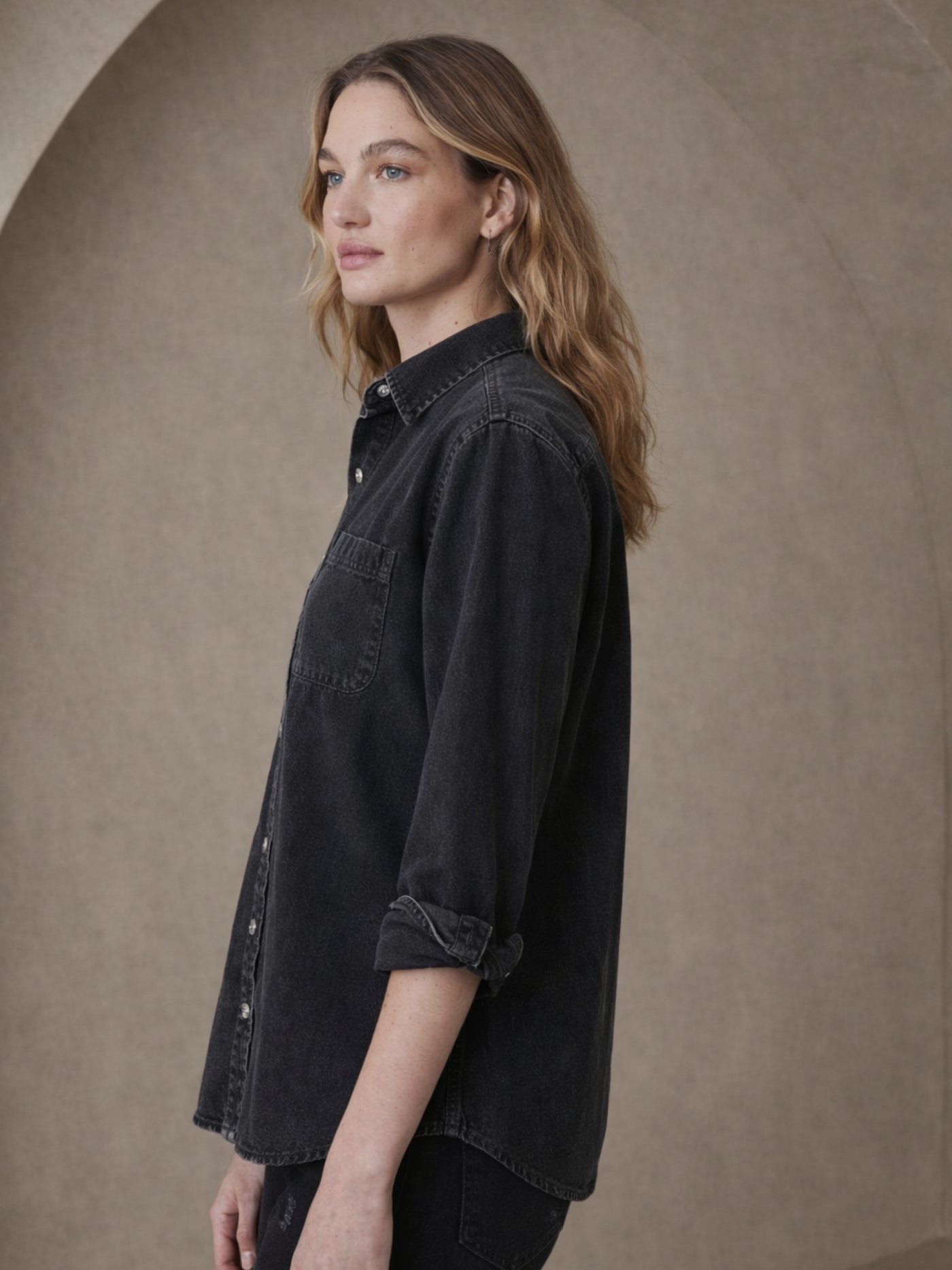 Close-up of chest pocket on black denim shirt