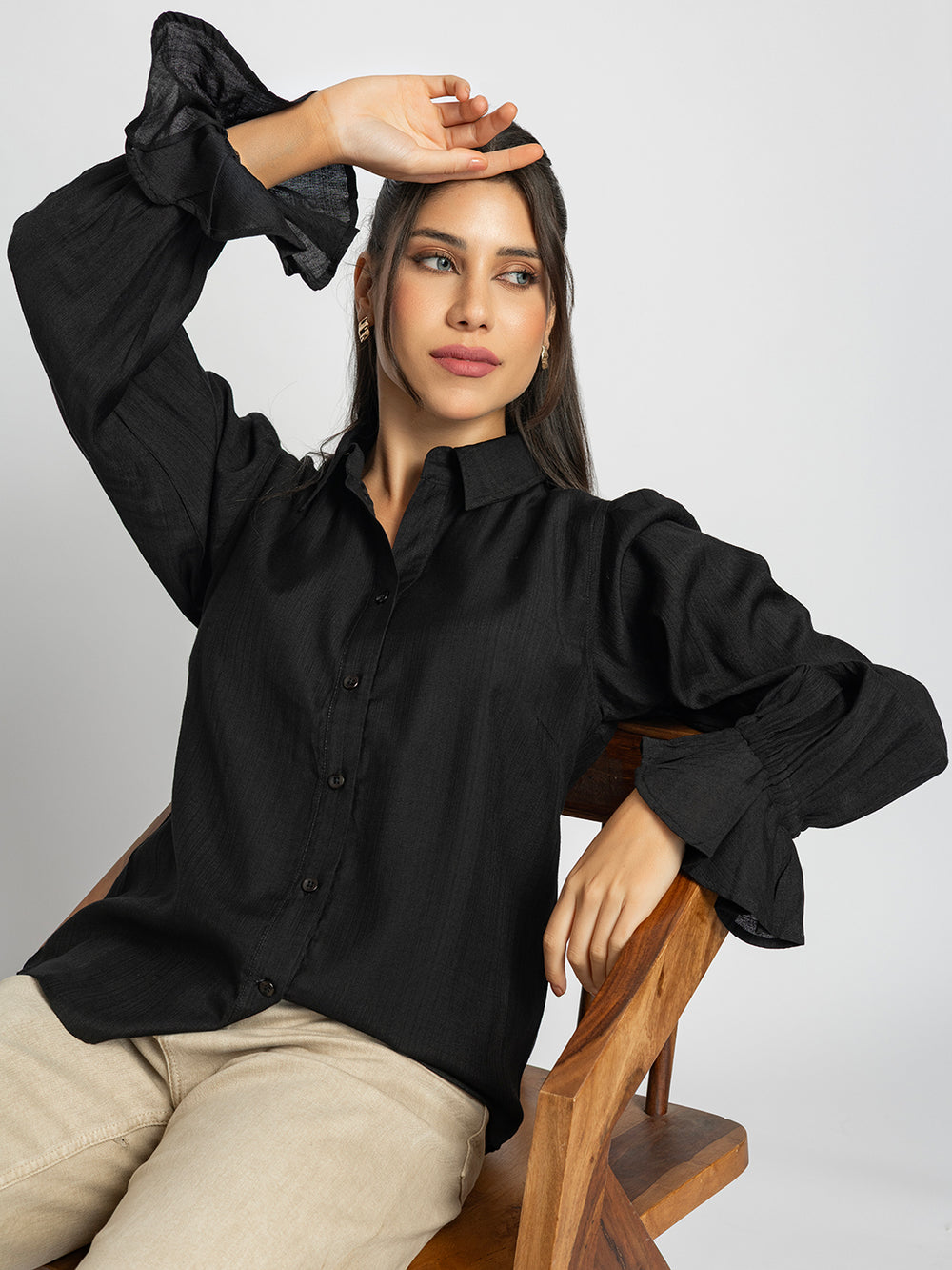 Side view of black ruffled cuff shirt