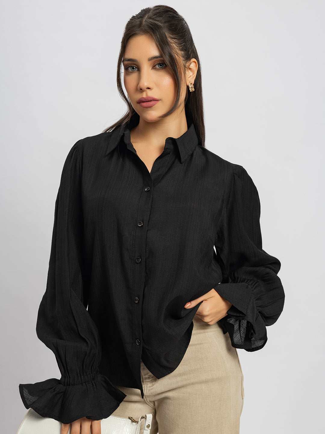 Lifestyle shot of black ruffled cuff shirt