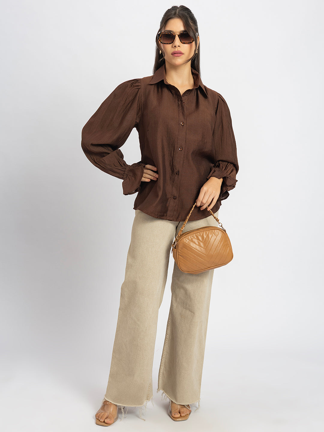 Back view of brown ruffled cuff shirt with curved hem