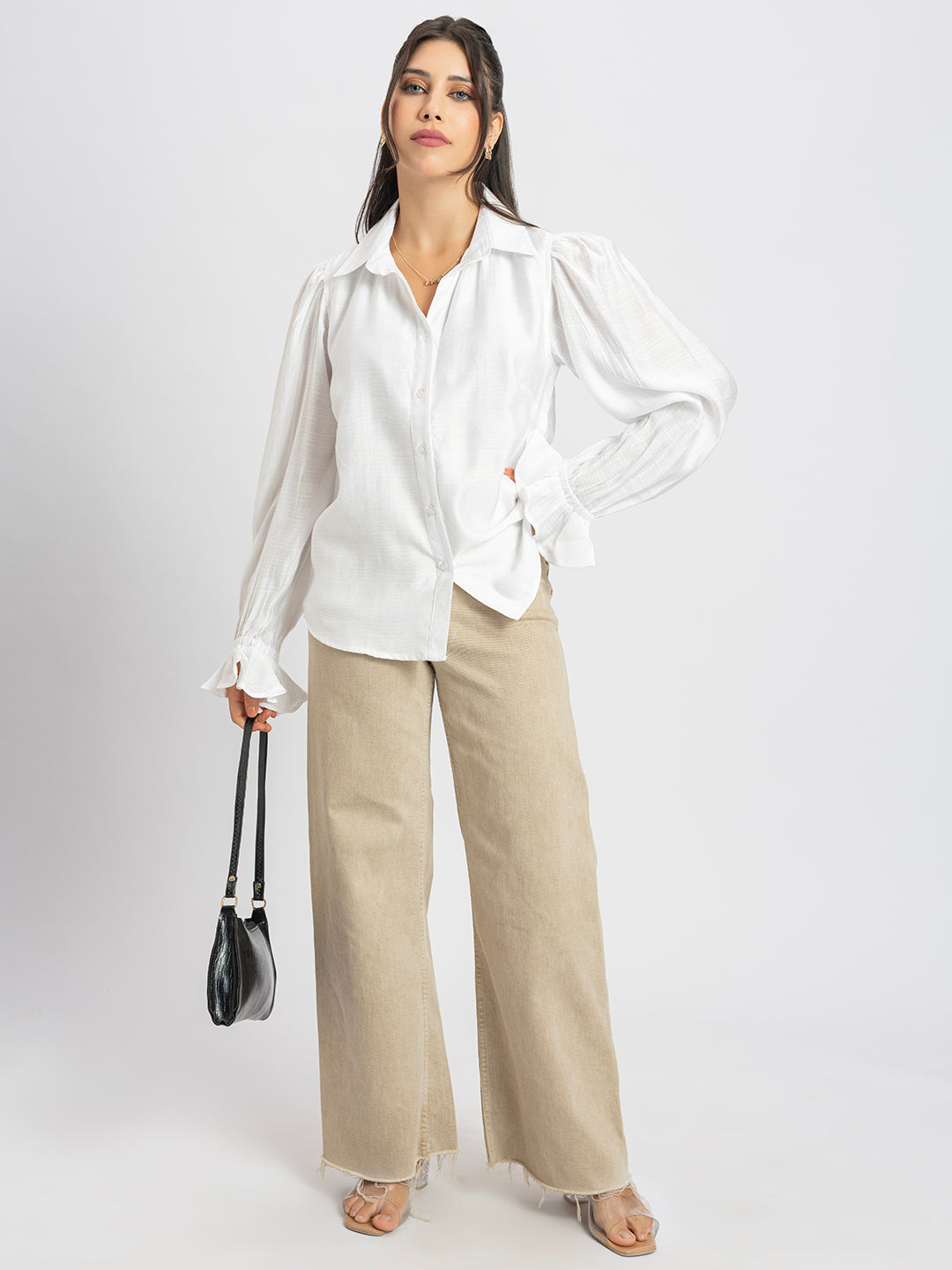 Close-up of ruffled cuff detail on white shirt