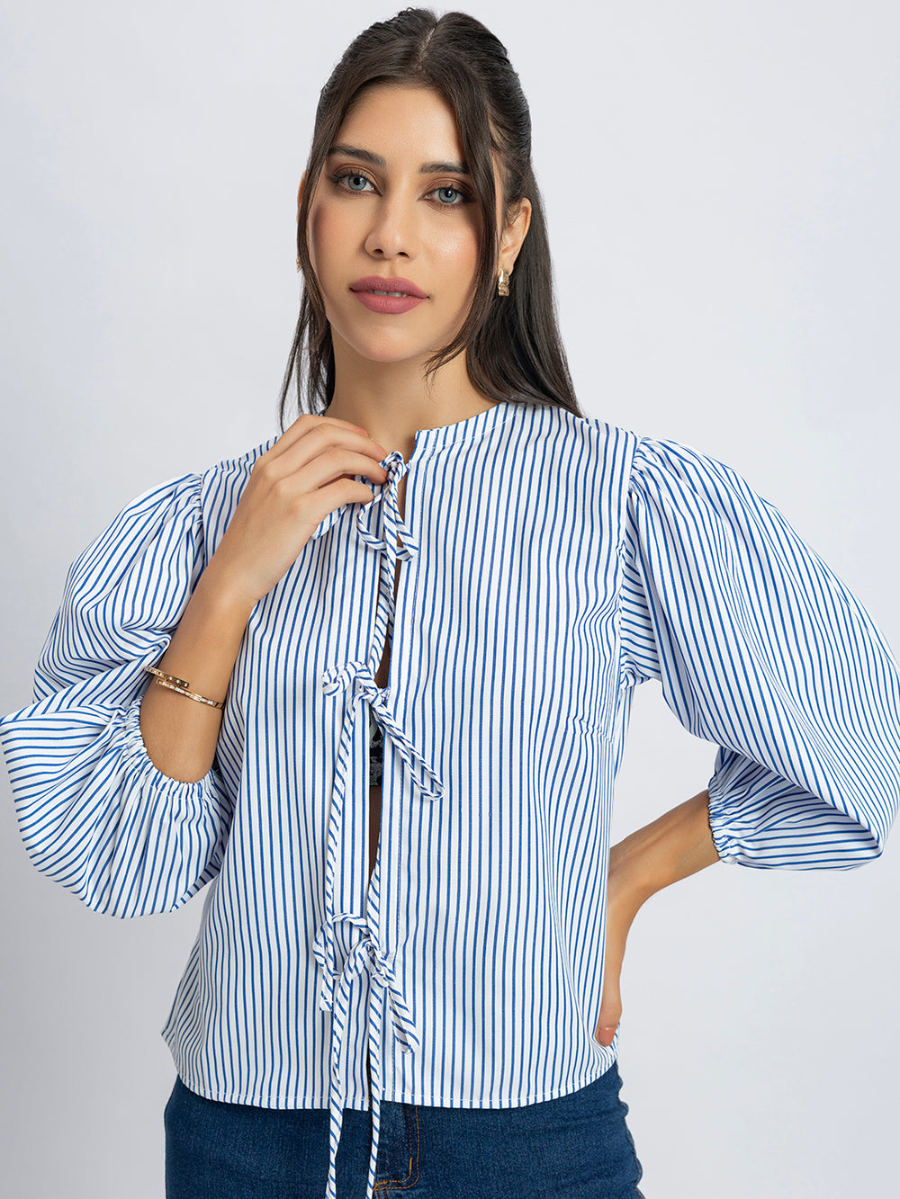 Side view of white and blue striped string top with round neck