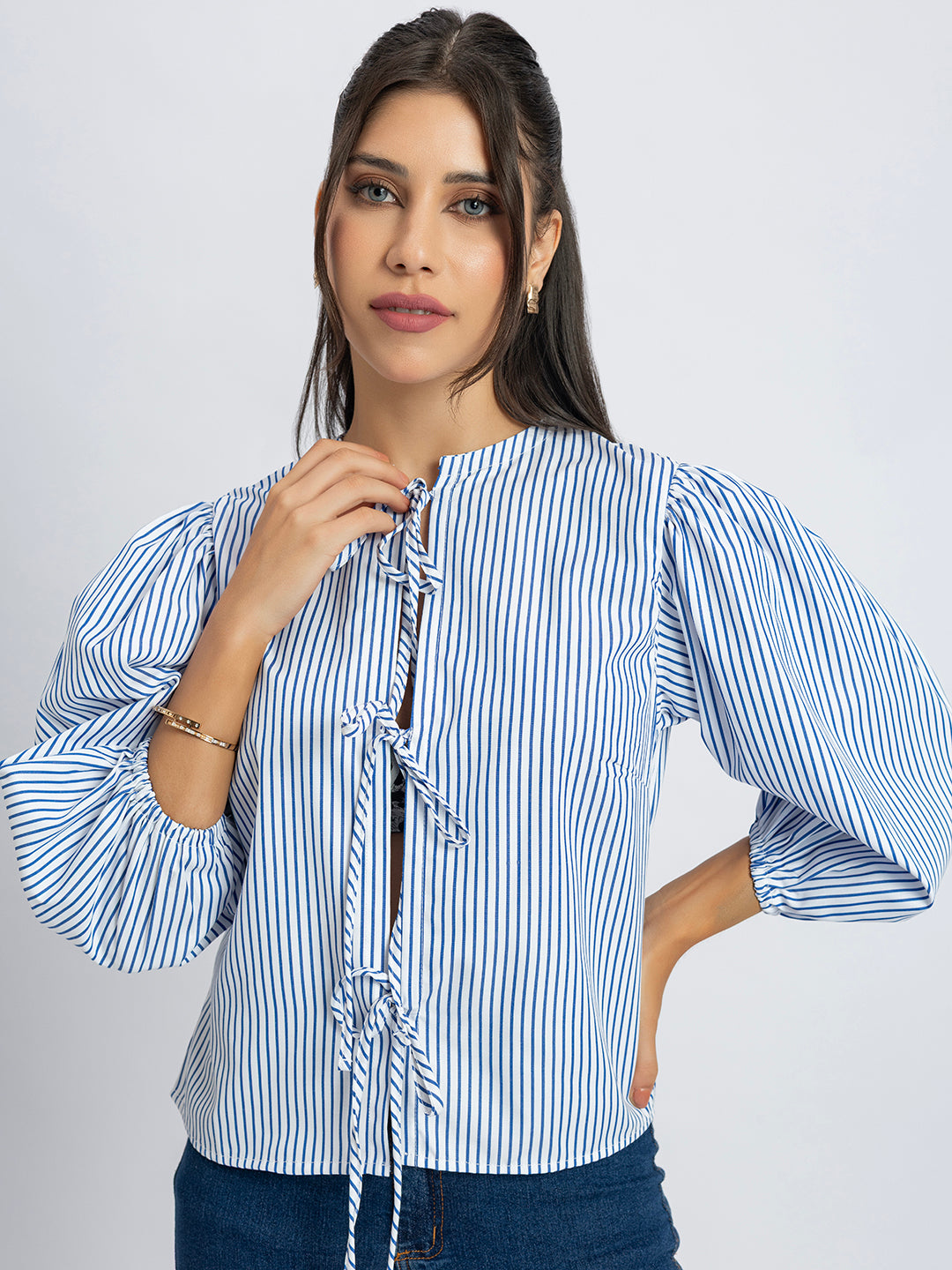 Side view of white and blue striped string top with round neck