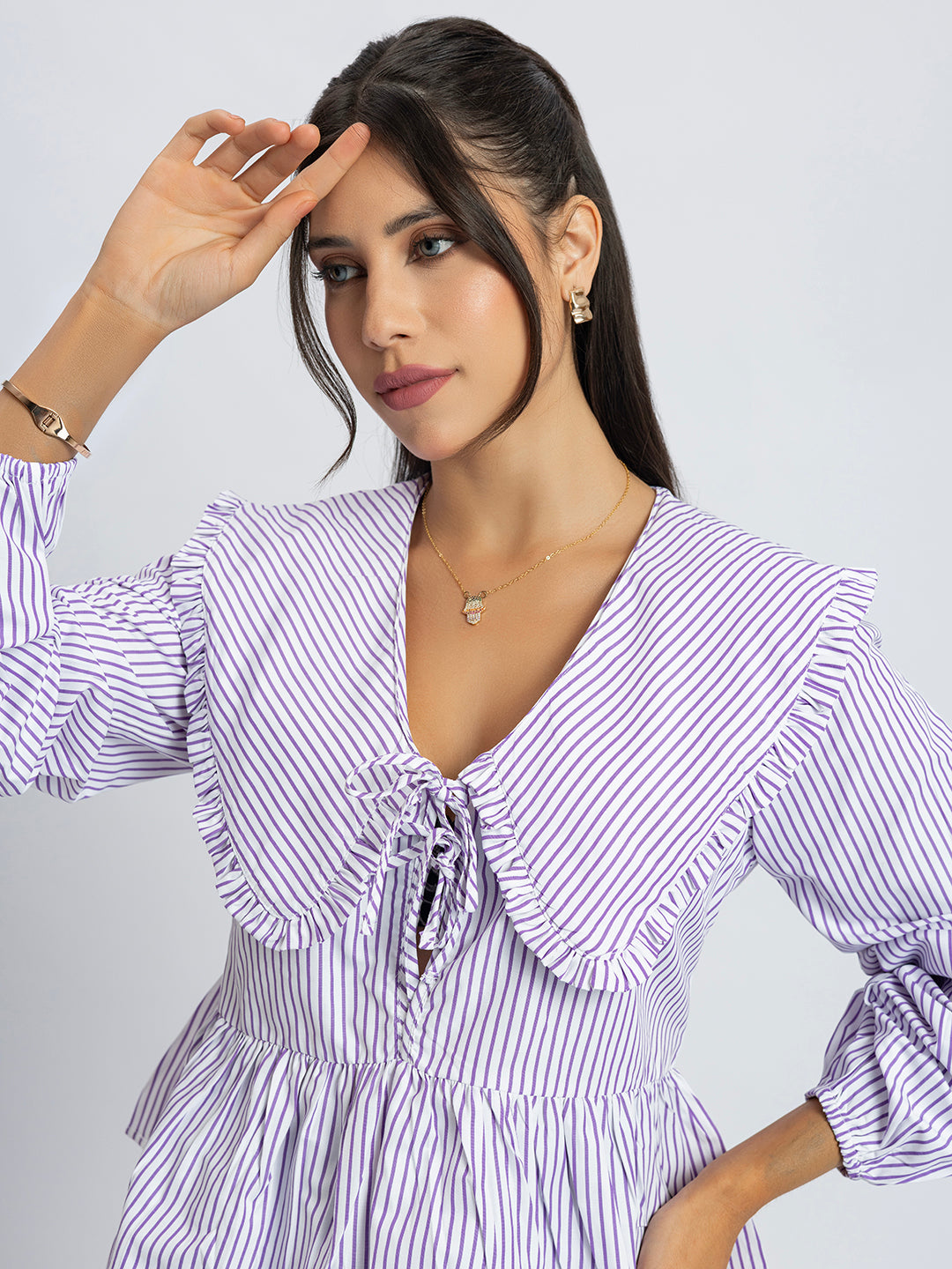 Back view of white and purple stripes peplum top
