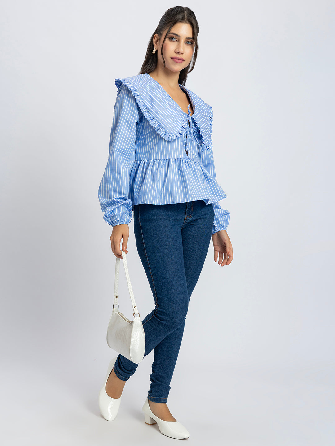 Lifestyle shot of blue and white striped peplum top