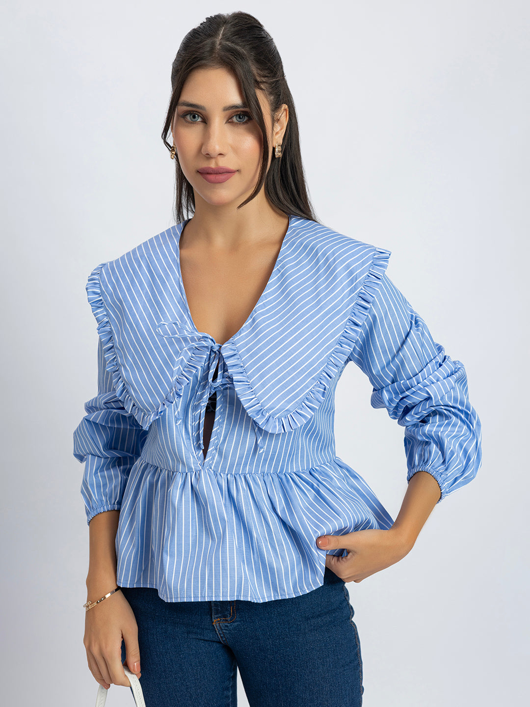 Detail of long sleeves on blue and white striped top