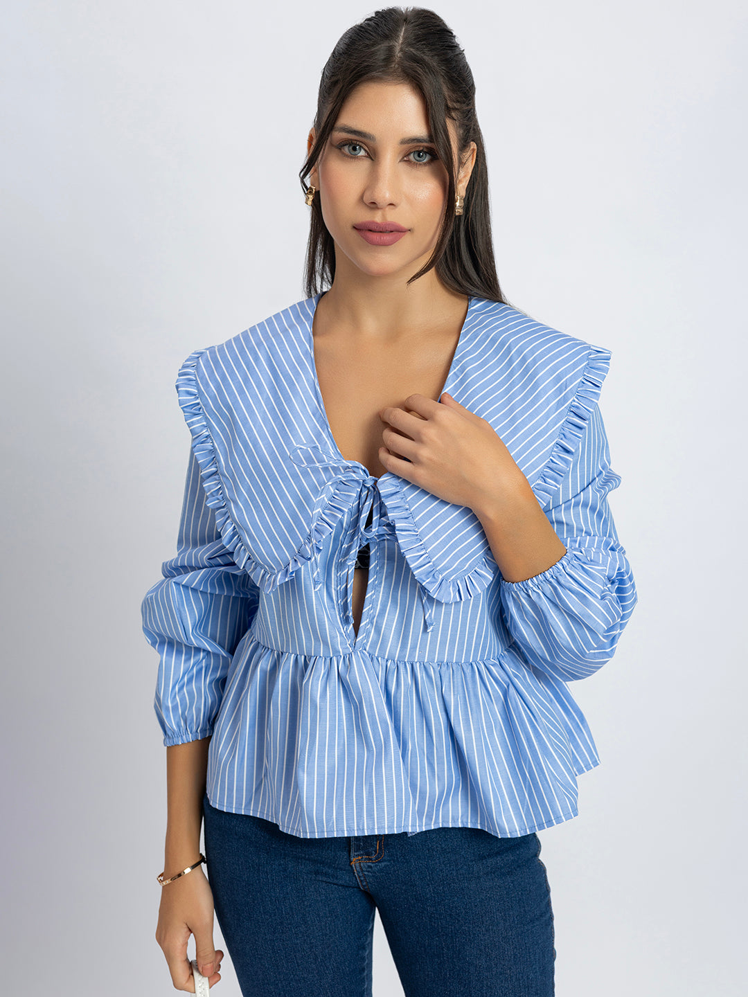 Hem detail of blue and white peplum top