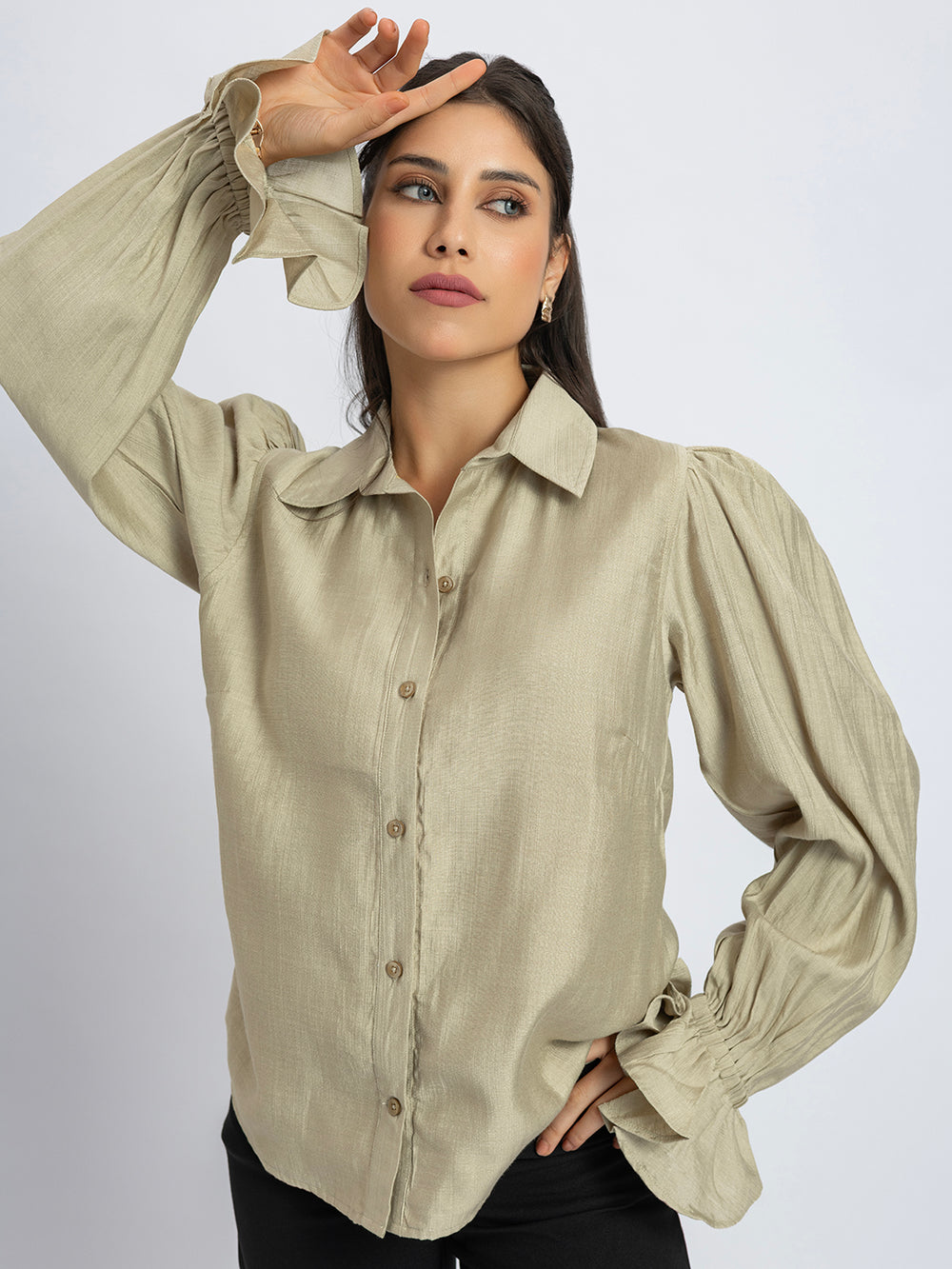 Side view of beige shirt with ruffled cuff detail