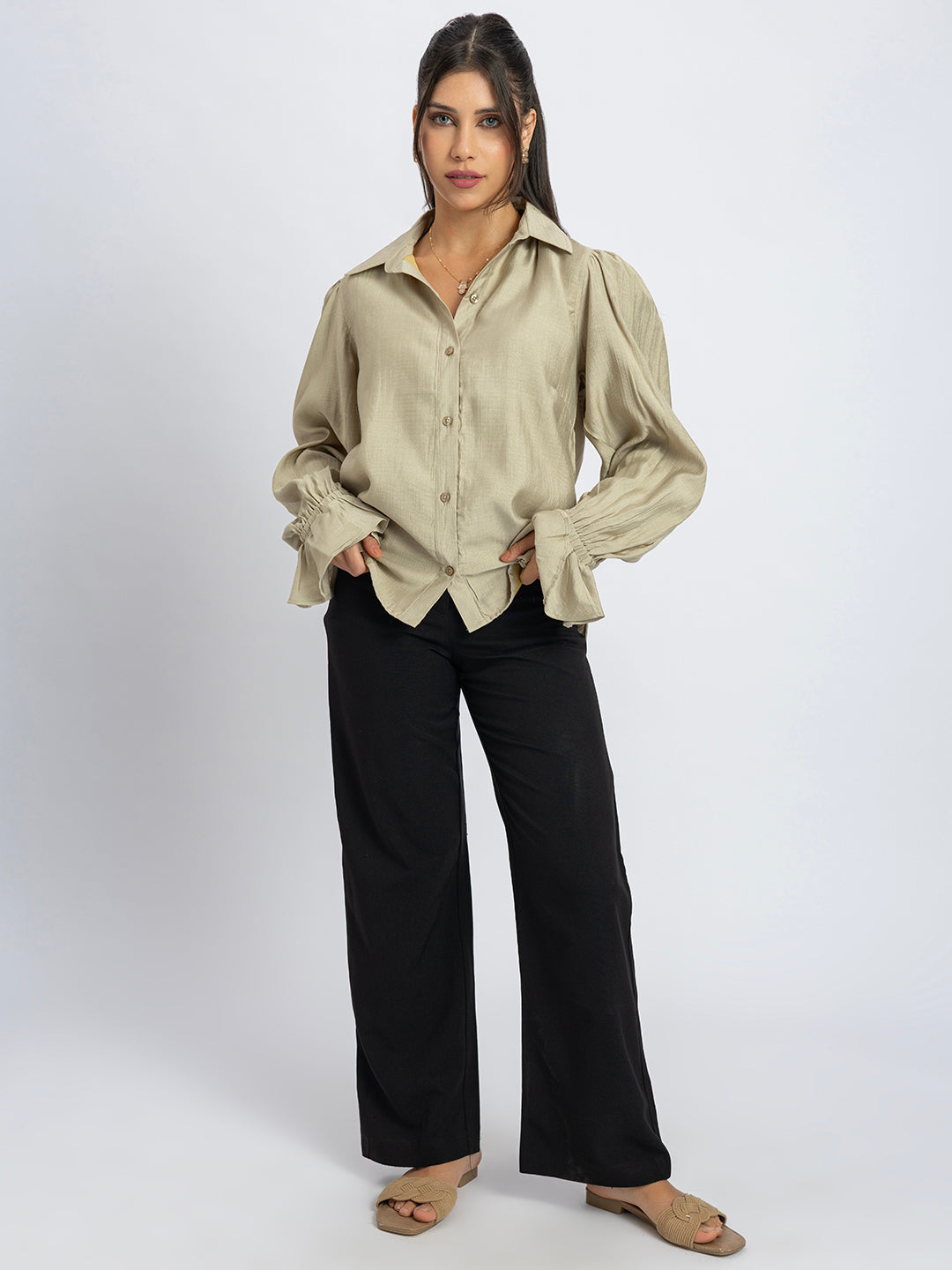 Close-up of ruffled cuff on beige shirt