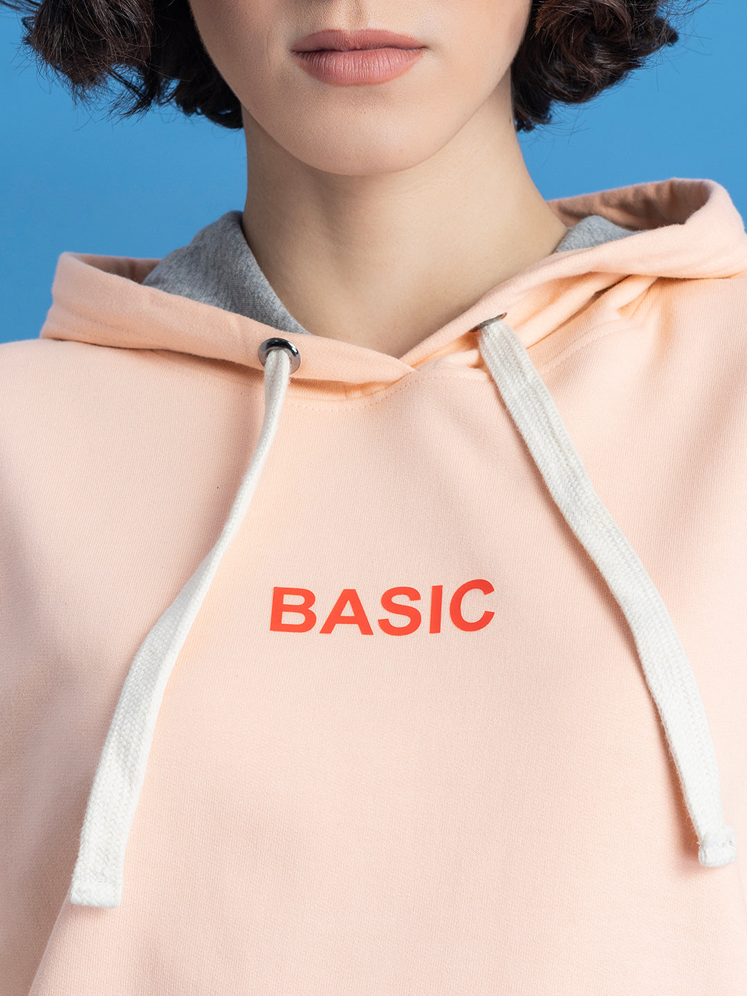 Close-up of kangaroo pocket on peach hoodie