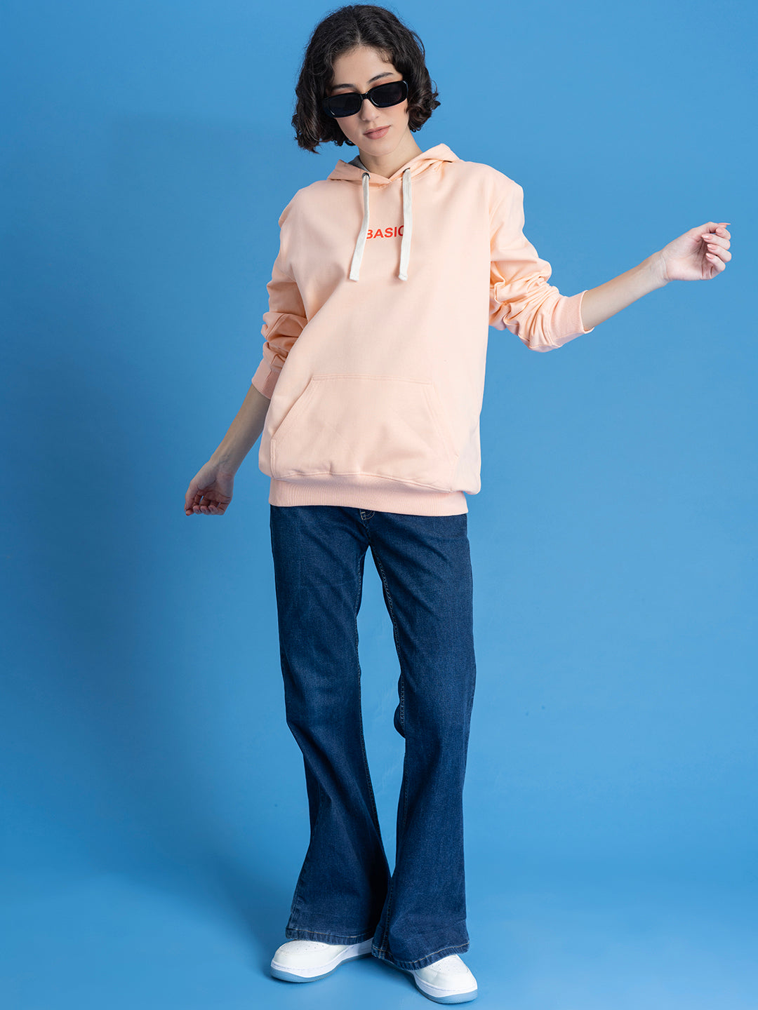 Detail of drawstring hood on peach hoodie