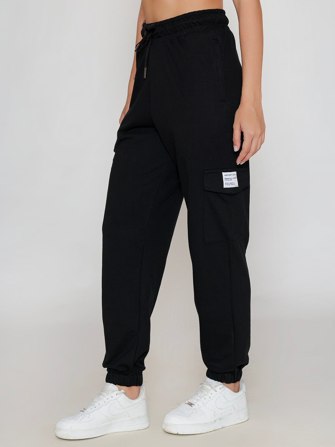 Detail of cargo pocket on black cotton pants