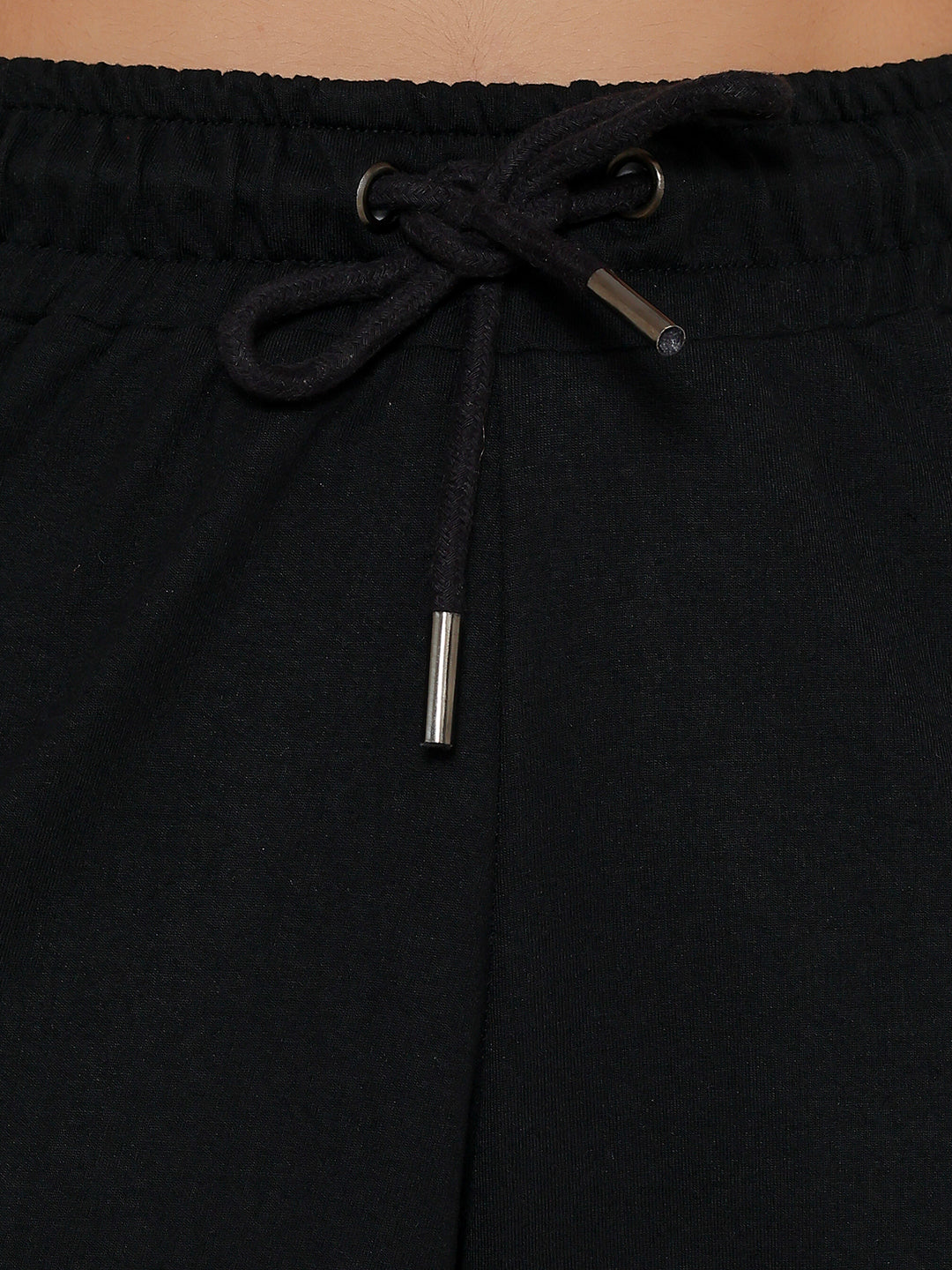 Lifestyle shot of black cargo pants with a tee