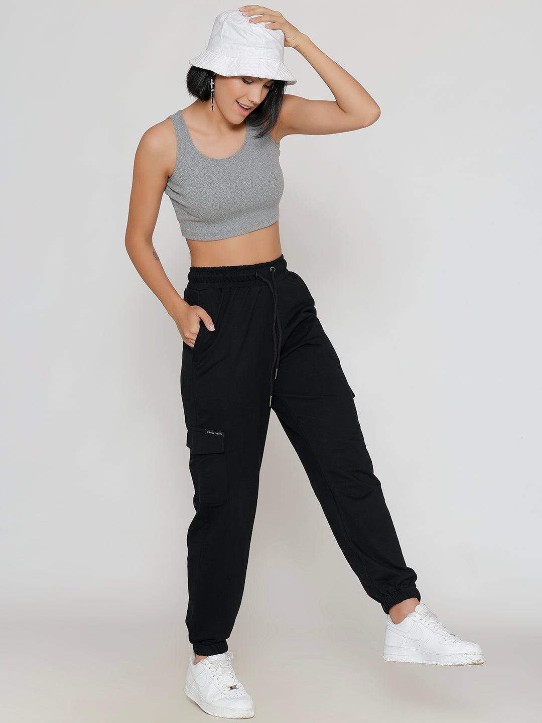 Side view of black cotton cargo pants showing cargo pocket