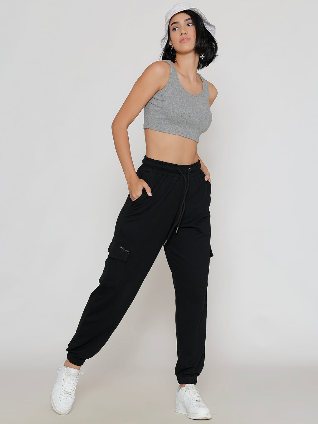 Model wearing black multi-pocket cotton cargo pants