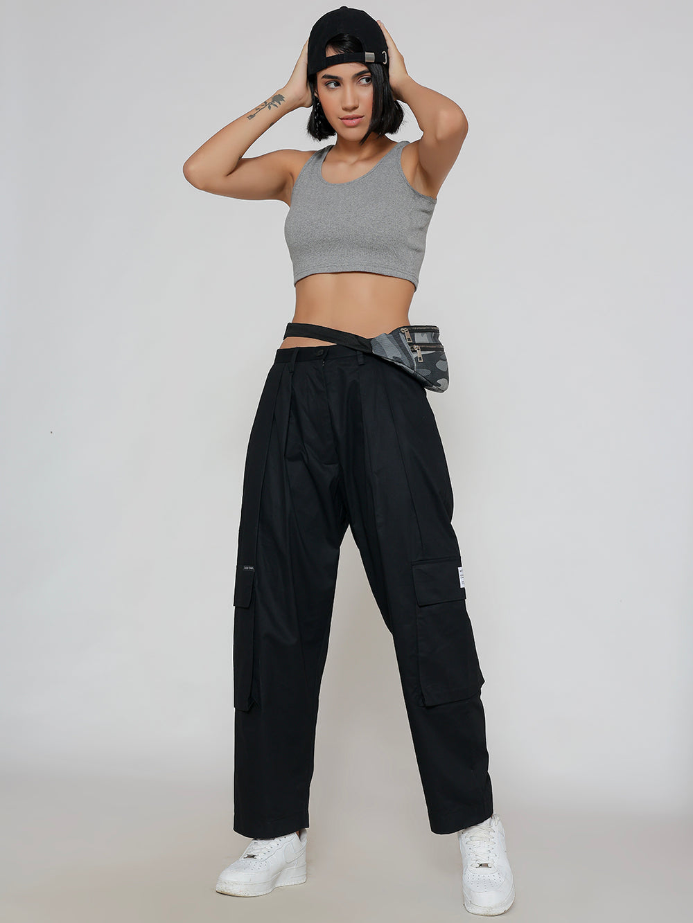 Side view of black cotton cargo pants showing cargo pocket