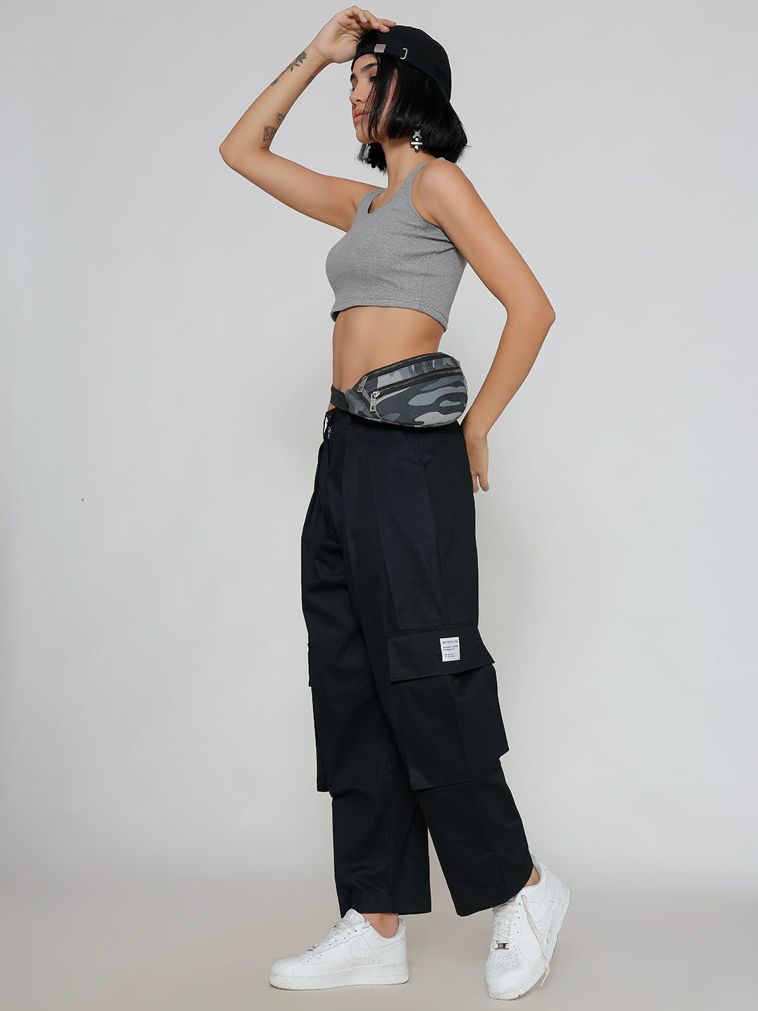Model wearing black cotton cargo pants in a casual look
