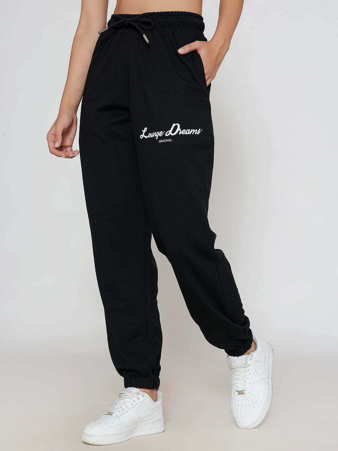 Lifestyle shot of black joggers styled with a tee