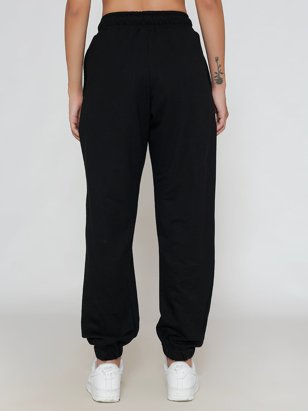 Detail of cuffed hem on black cotton joggers