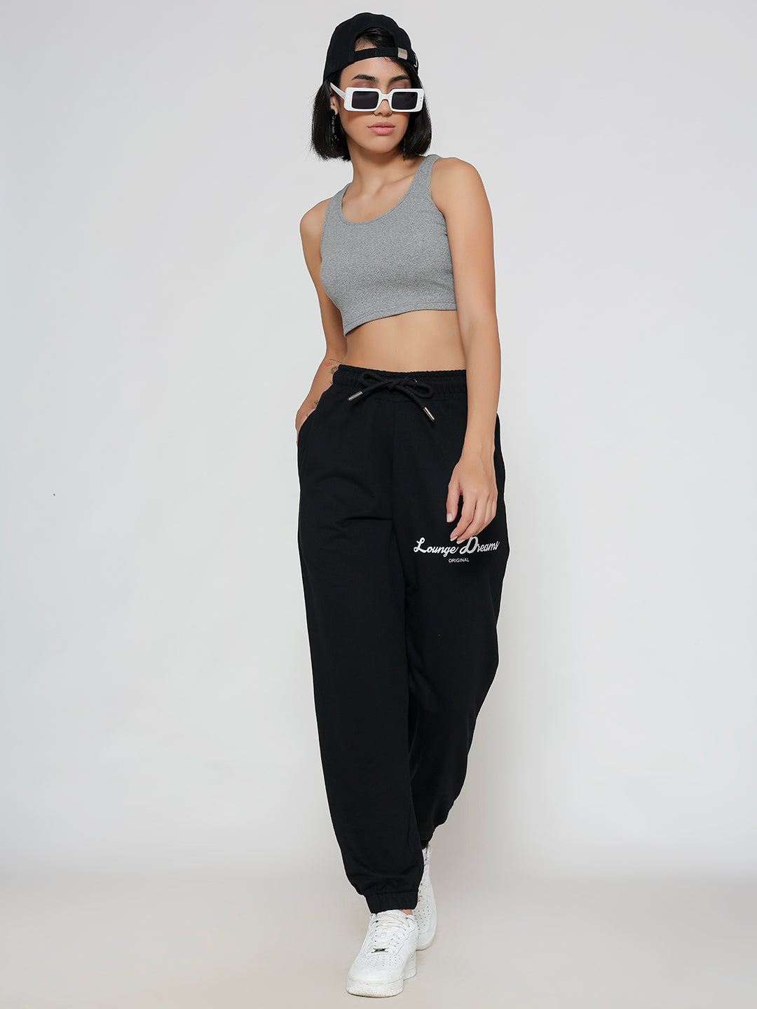 Model wearing black cotton joggers in a casual look