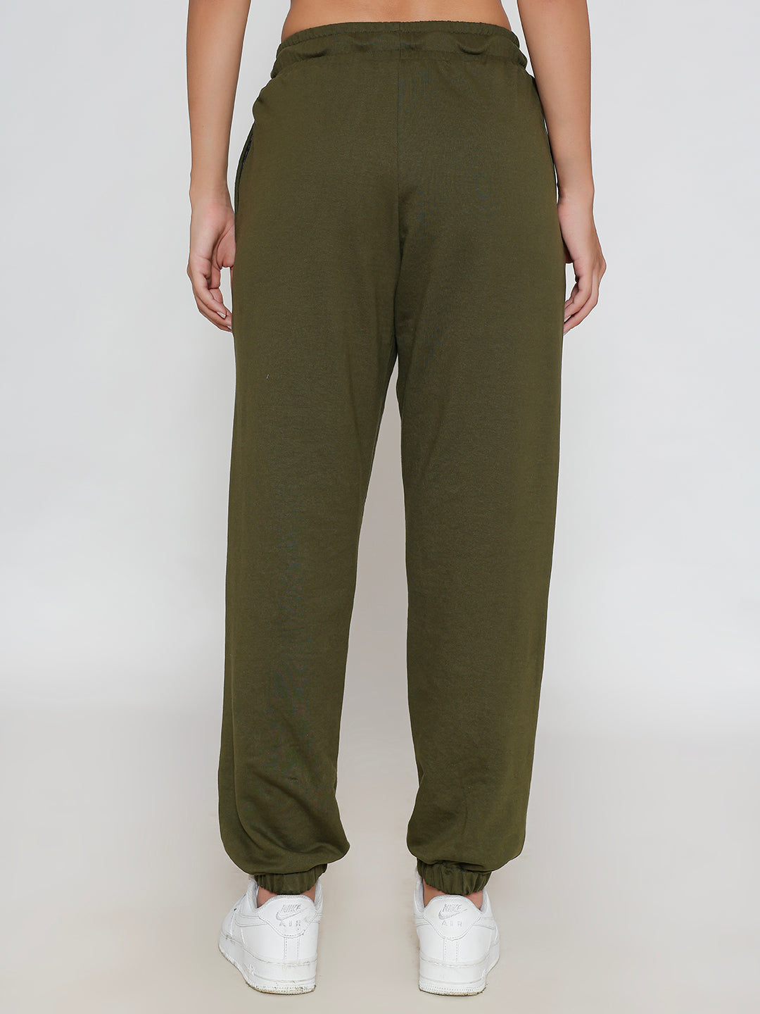 Lifestyle shot of olive joggers styled with a tee