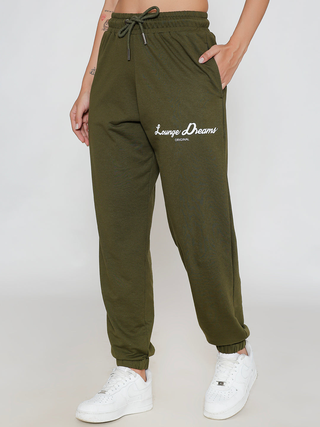 Close-up of elastic waistband on olive knit joggers