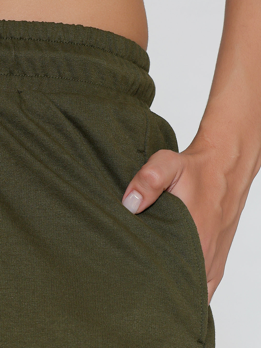 Model wearing olive cotton joggers in a casual look