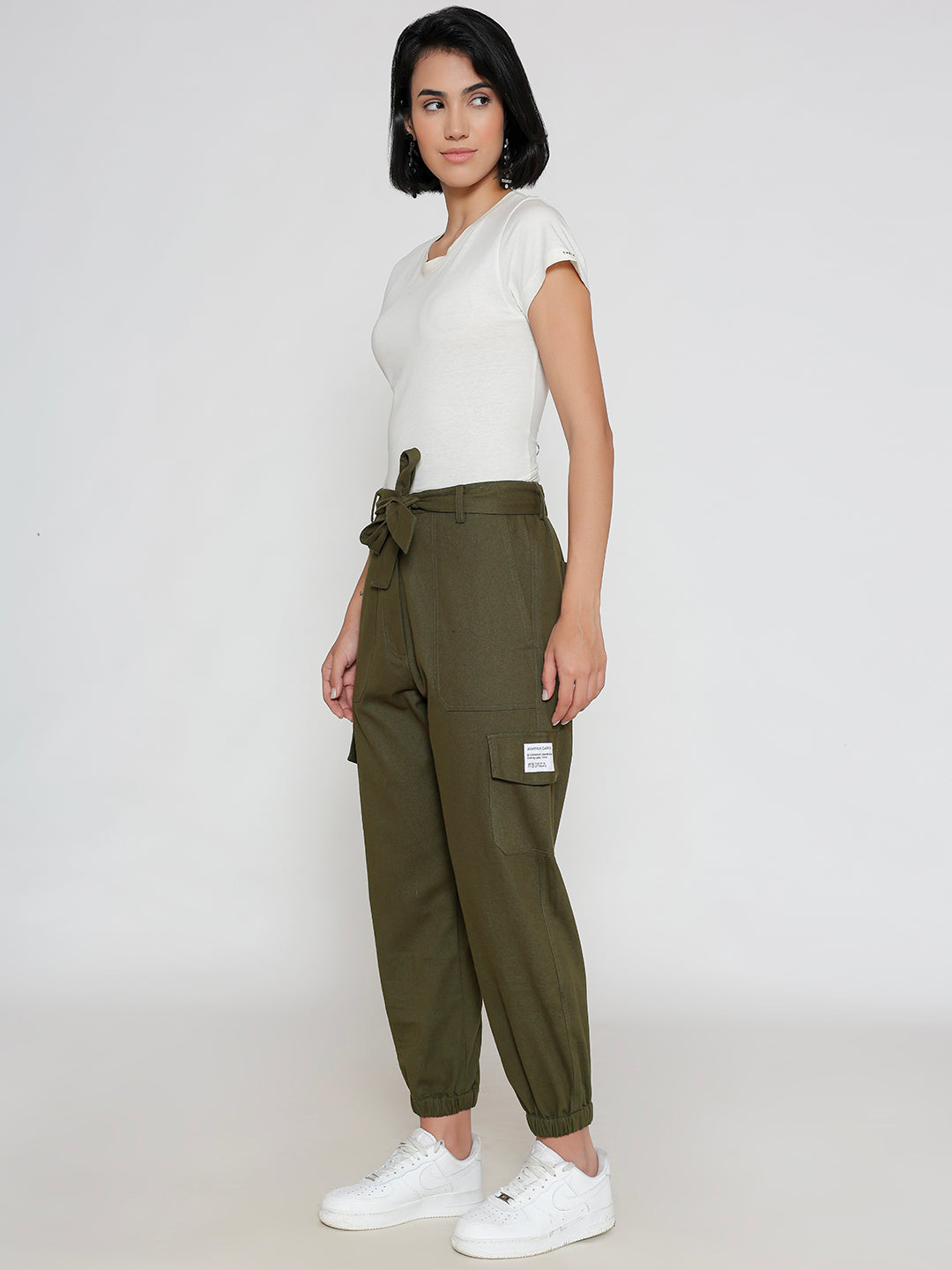 Model wearing olive cotton cargo pants in a casual look