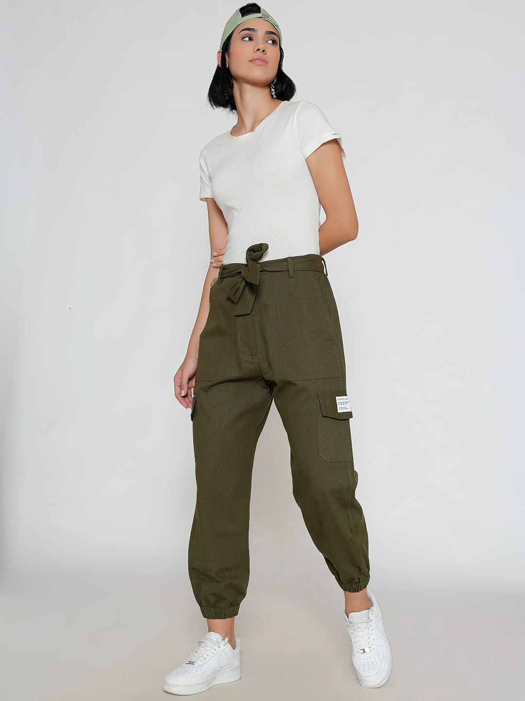 Model wearing olive cotton cargo pants in a casual look