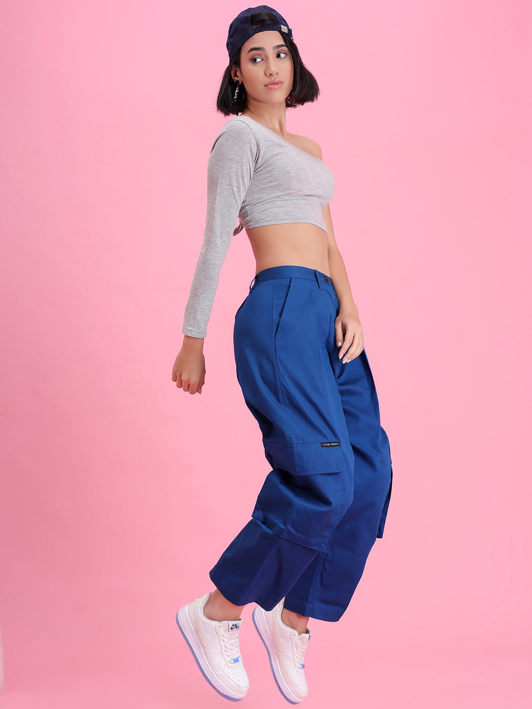 Model wearing navy cotton cargo pants in a casual look