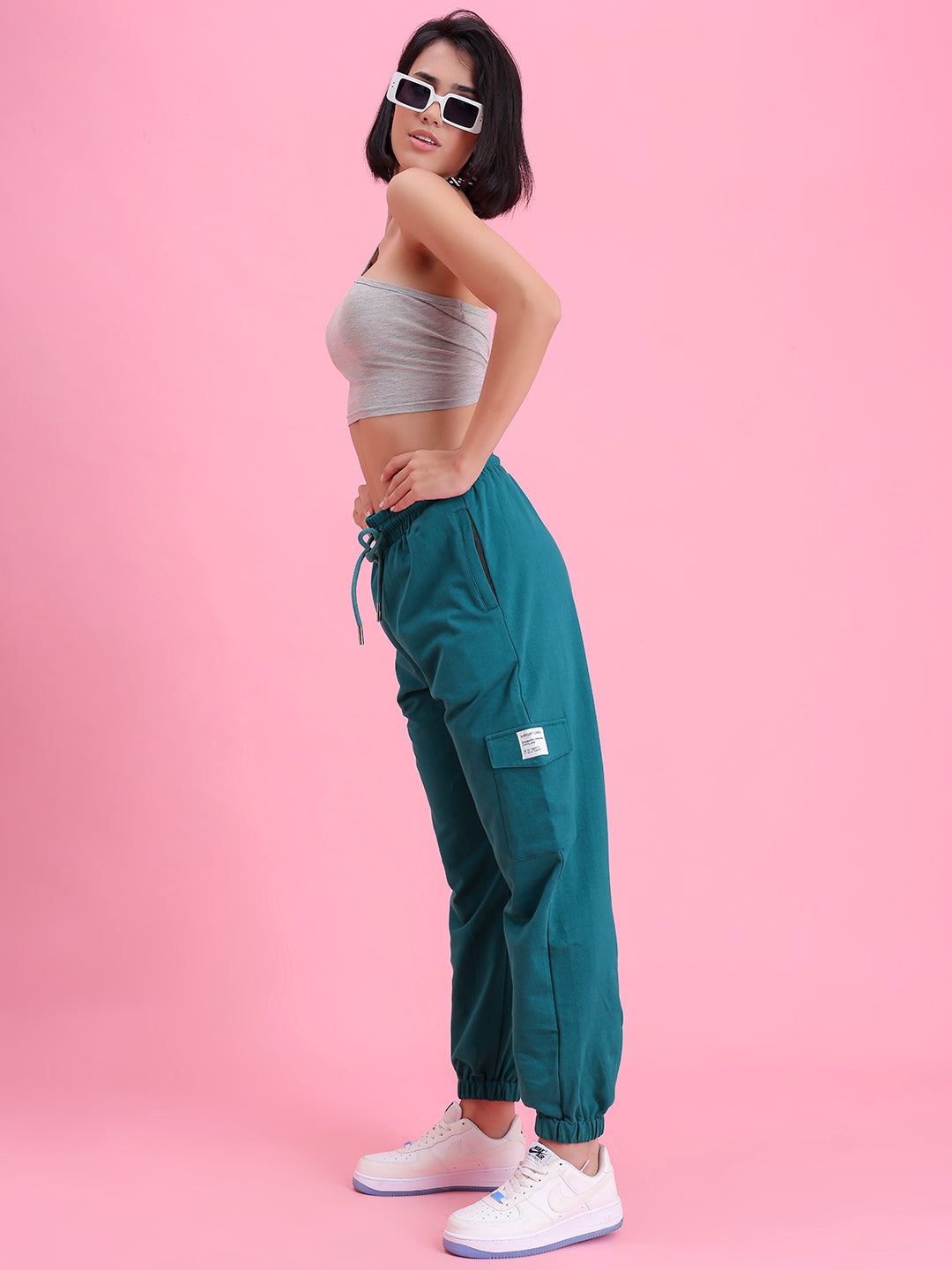 Lifestyle shot of teal cargo pants with a tee