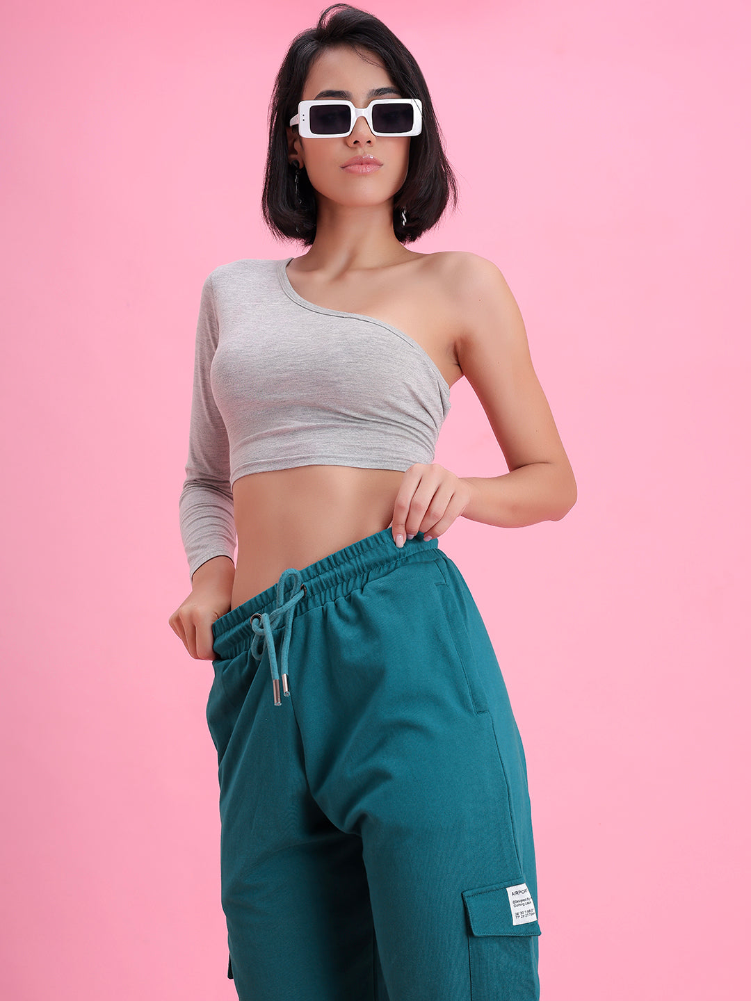Model wearing teal cotton cargo pants in a casual look