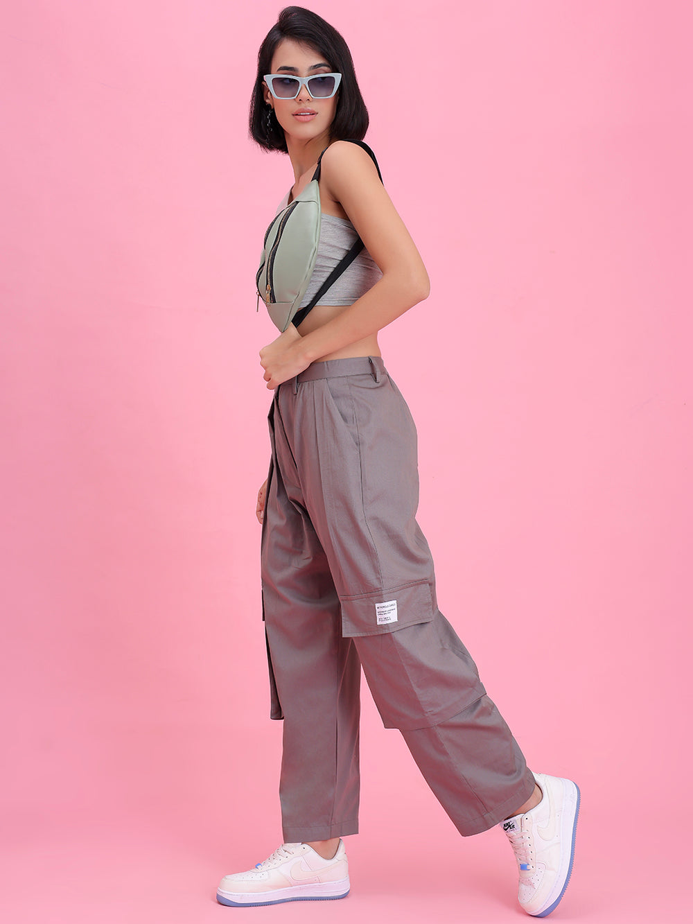 Side view of grey cotton cargo pants showing cargo pocket