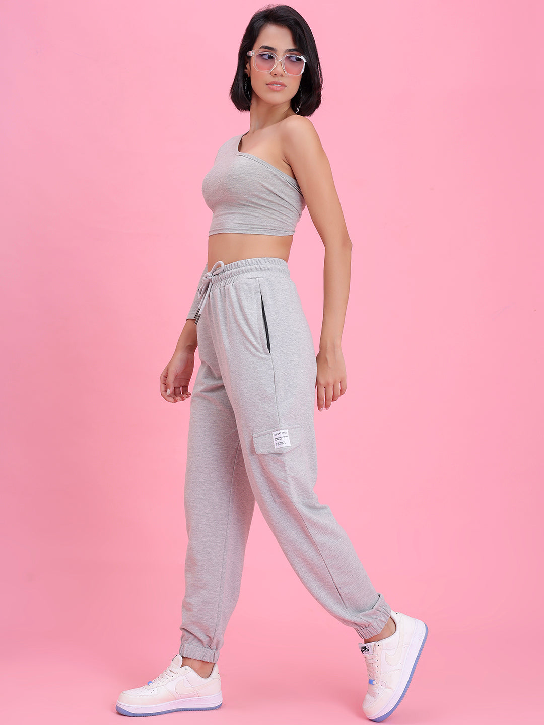 Lifestyle shot of grey utility cargo pants with a tee