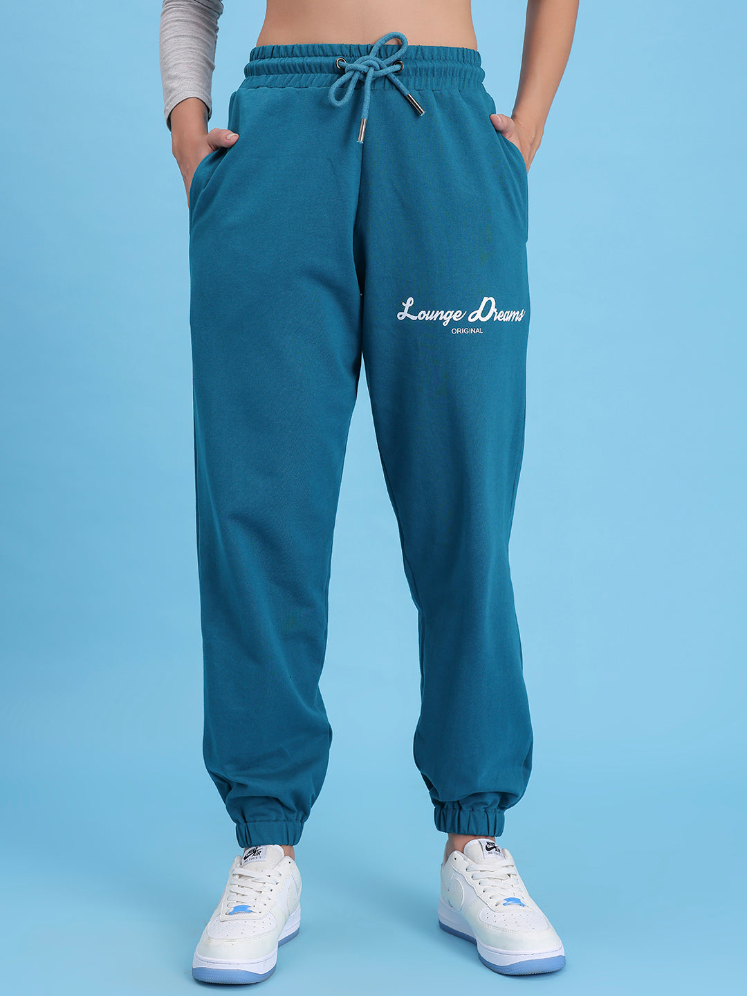 Detail of cuffed hem on teal cotton joggers