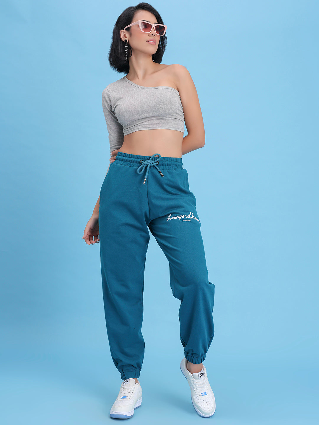 Lifestyle shot of teal joggers styled with a tee